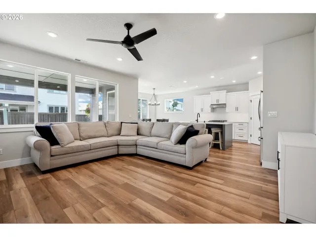 a living room with furniture and a ceiling fan