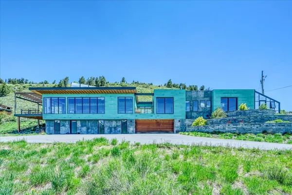 a view of a house with a yard and sitting area