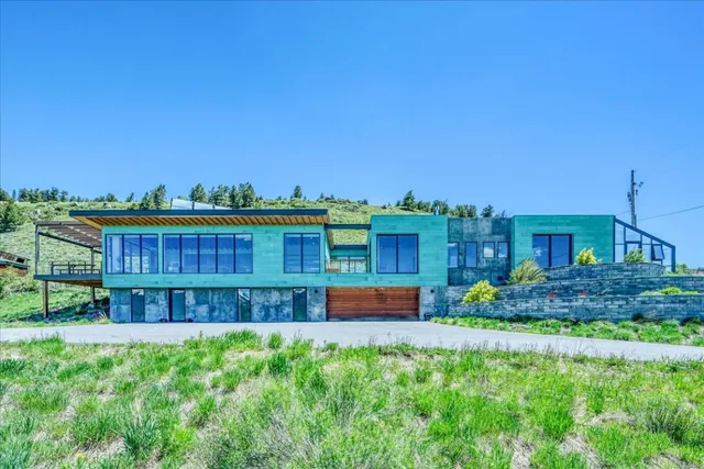 a view of a house with a yard and sitting area