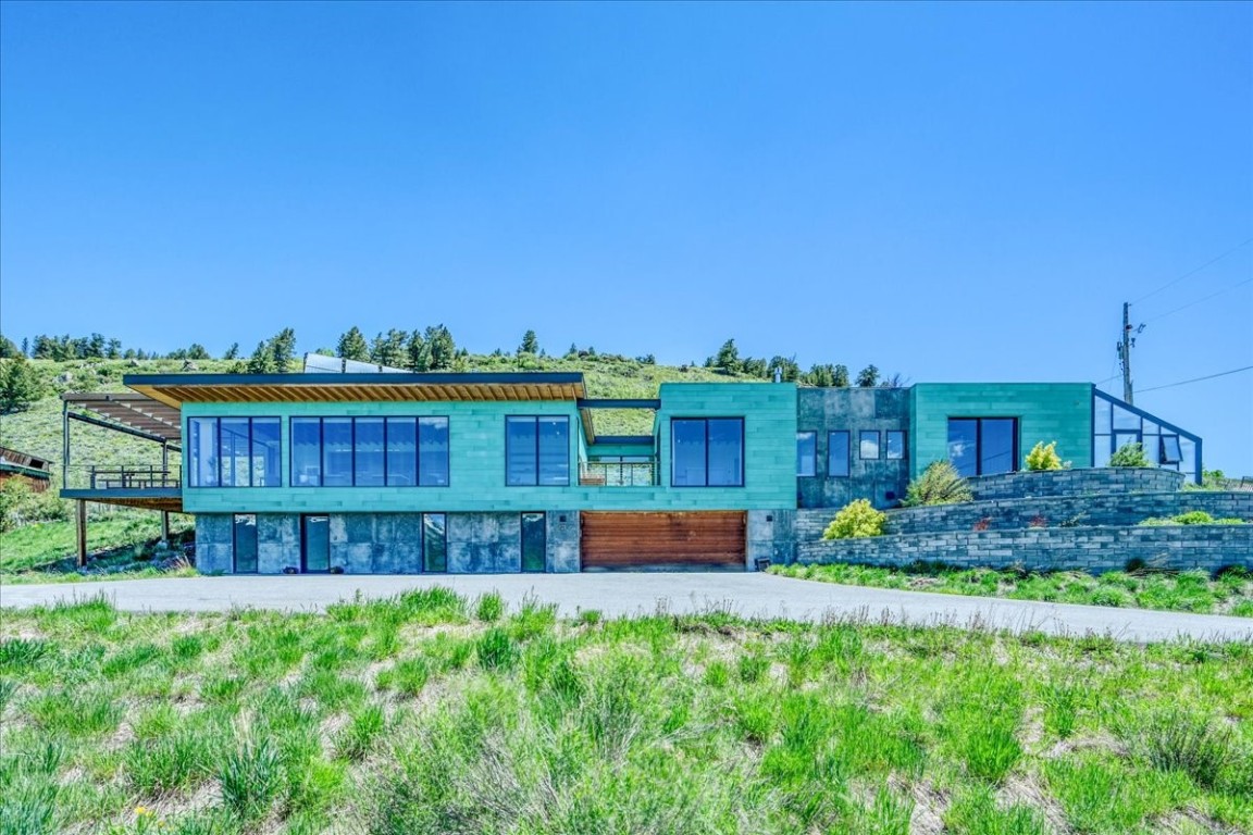 a view of a house with a yard and sitting area
