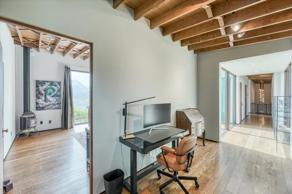 a view of a workspace with furniture and a window