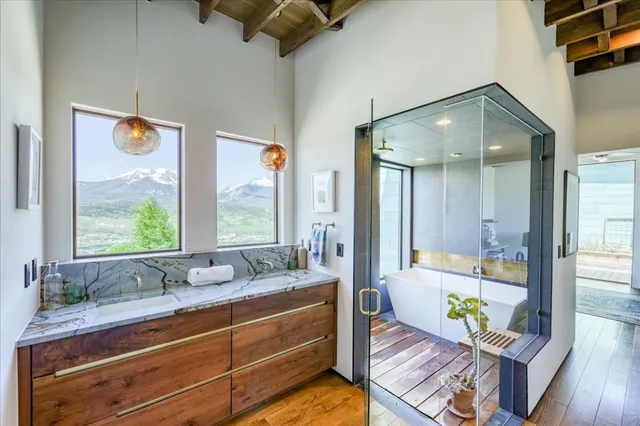 a spacious bathroom with a granite countertop sink and a large mirror