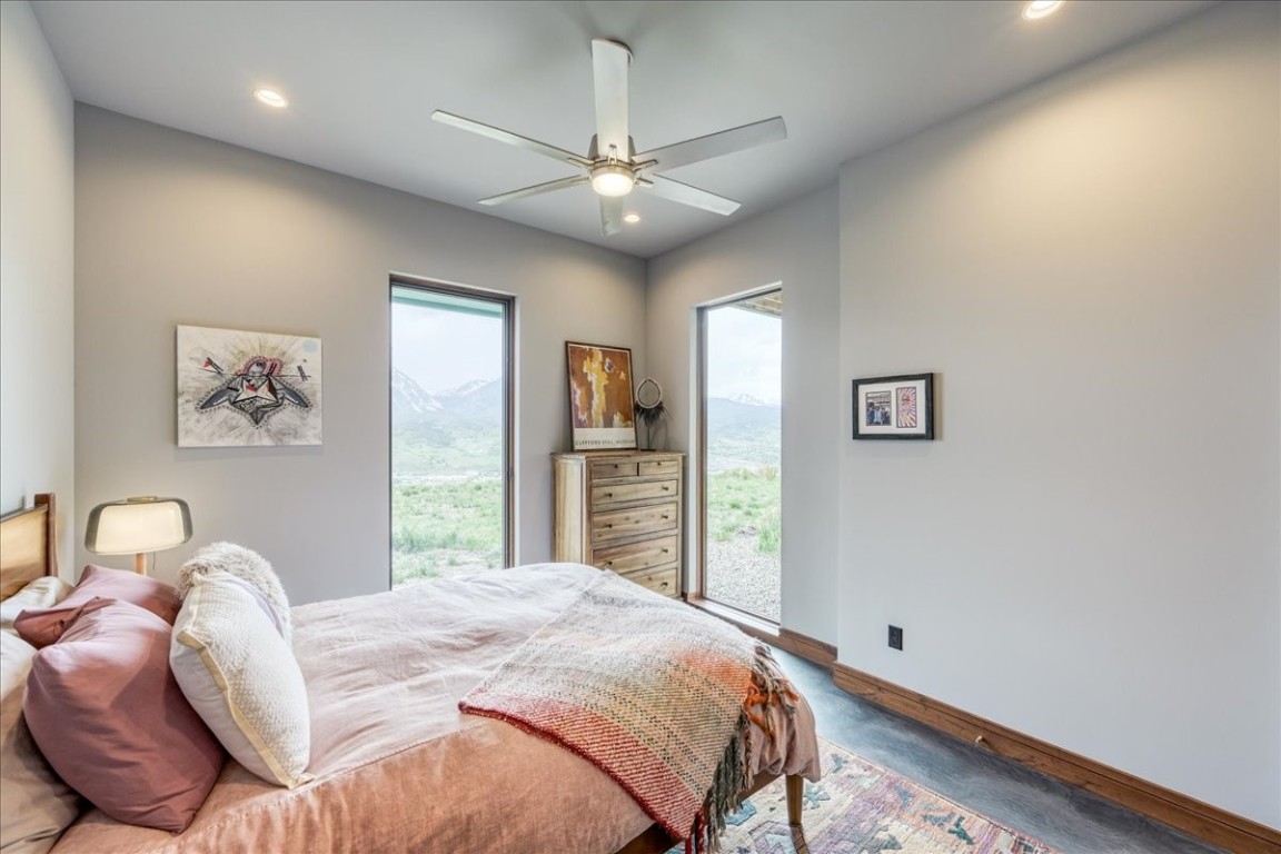 421 Z Road Silverthorne, CO 80498 - Photo 31 of 47 a bedroom with a large bed and a chandelier