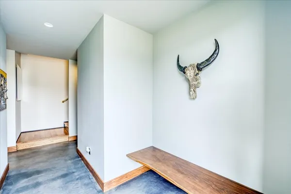 a view of a room with wooden floor and a ceiling fan