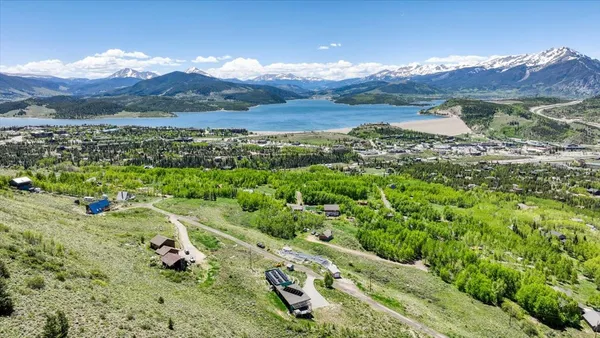 a view of a lush green hillside and houses