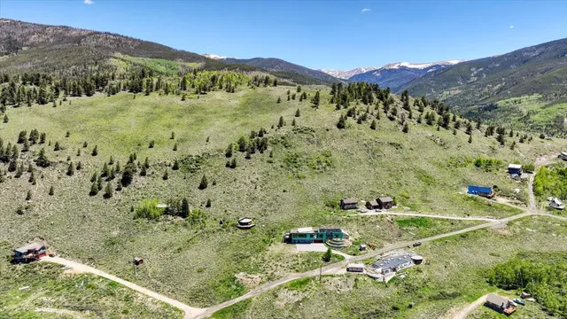 a view of a lush green hillside and houses