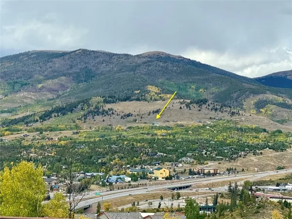 a view of a mountain with a field
