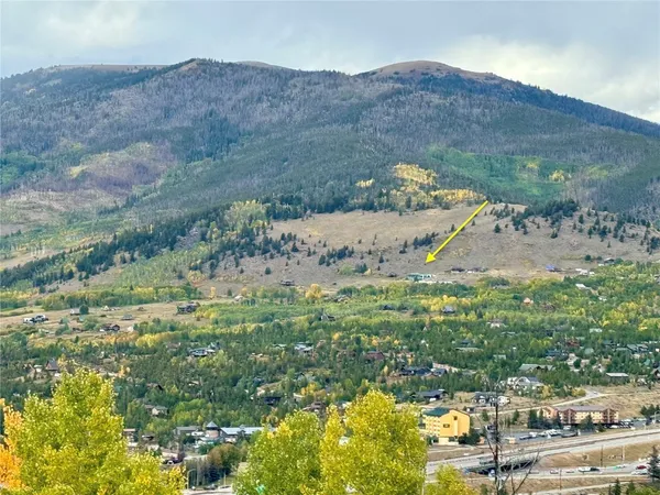 a view of a field with mountains in the background