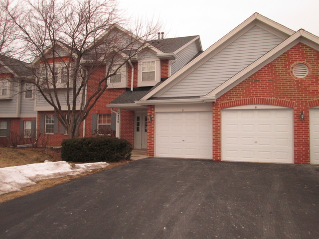 2426 Raleigh Court, Unit 6 Schaumburg, IL 60193 - Photo 1 of 18 a front view of a house with a yard and garage