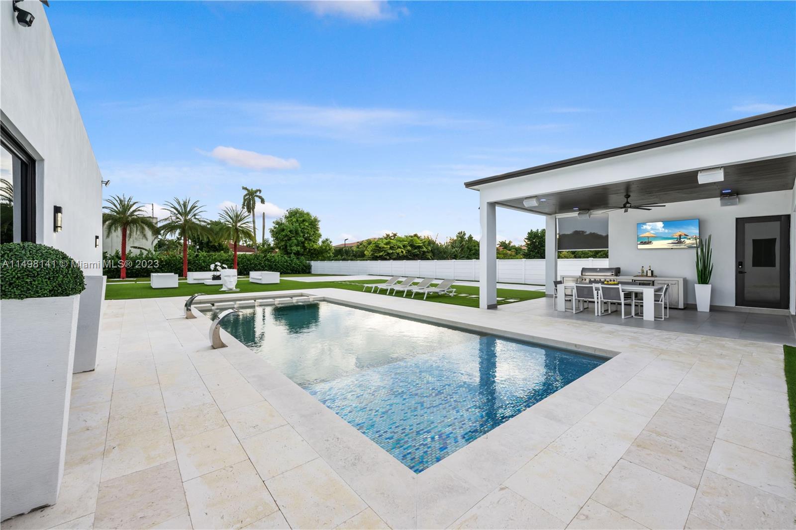 13310 Southwest 34th Street Miami, FL 33175 - Photo 13 of 54 a view of a swimming pool with chairs