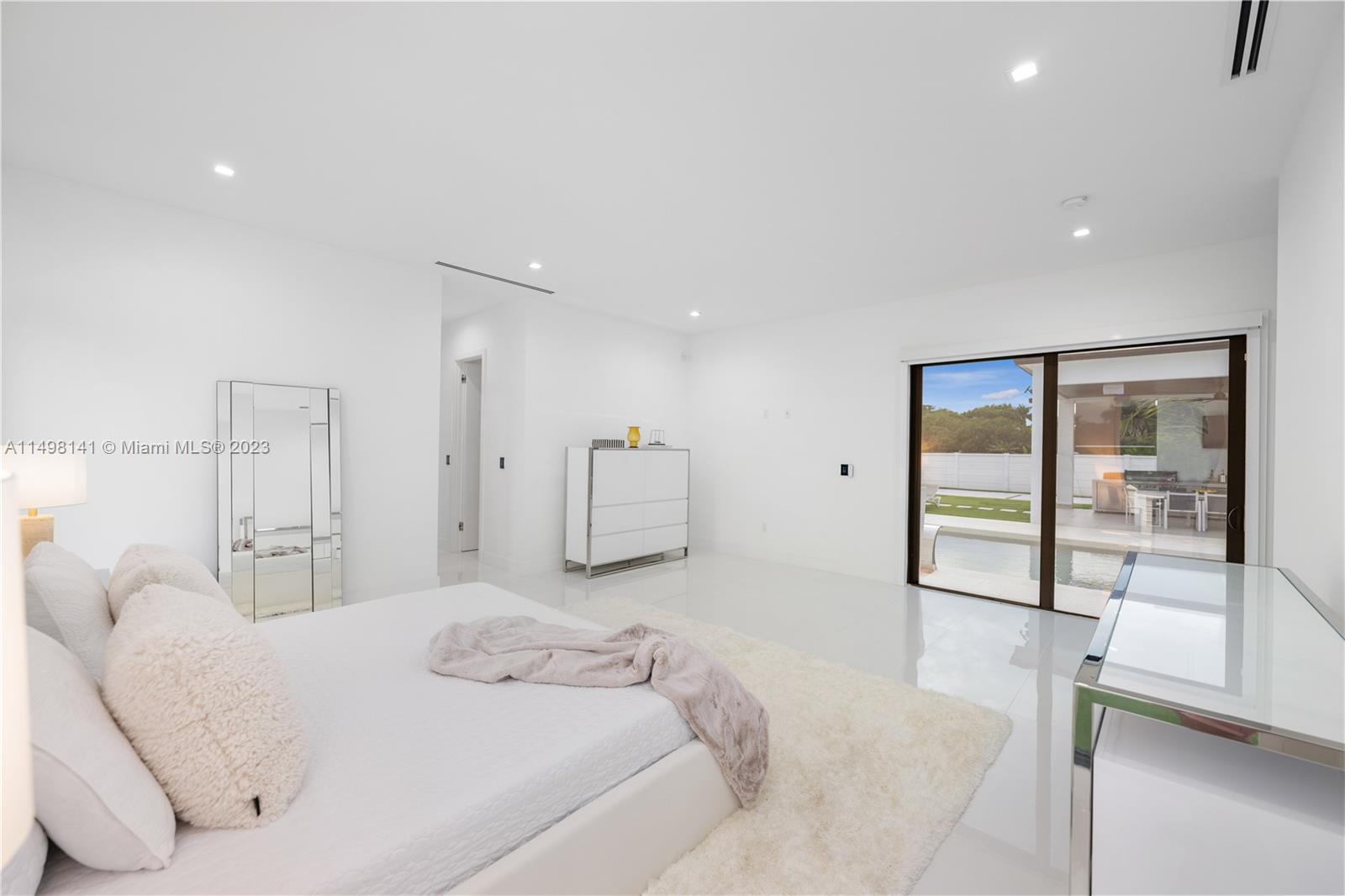 13310 Southwest 34th Street Miami, FL 33175 - Photo 17 of 54 a spacious bedroom with a bed and a large window