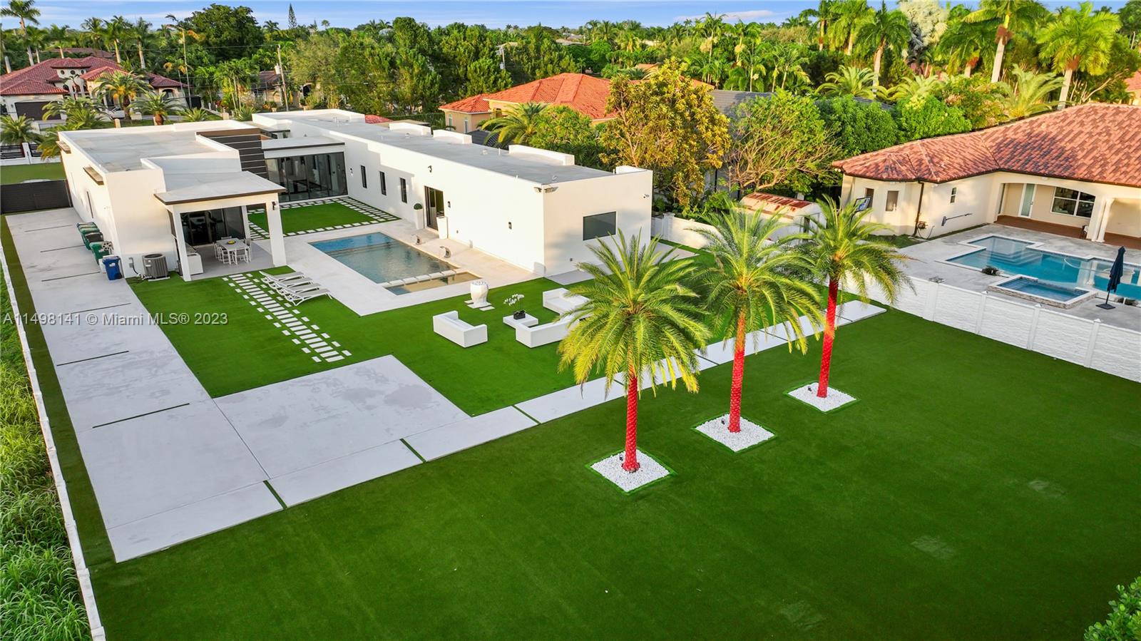 13310 Southwest 34th Street Miami, FL 33175 - Photo 2 of 54 a view of an house with backyard outdoor seating area and green space