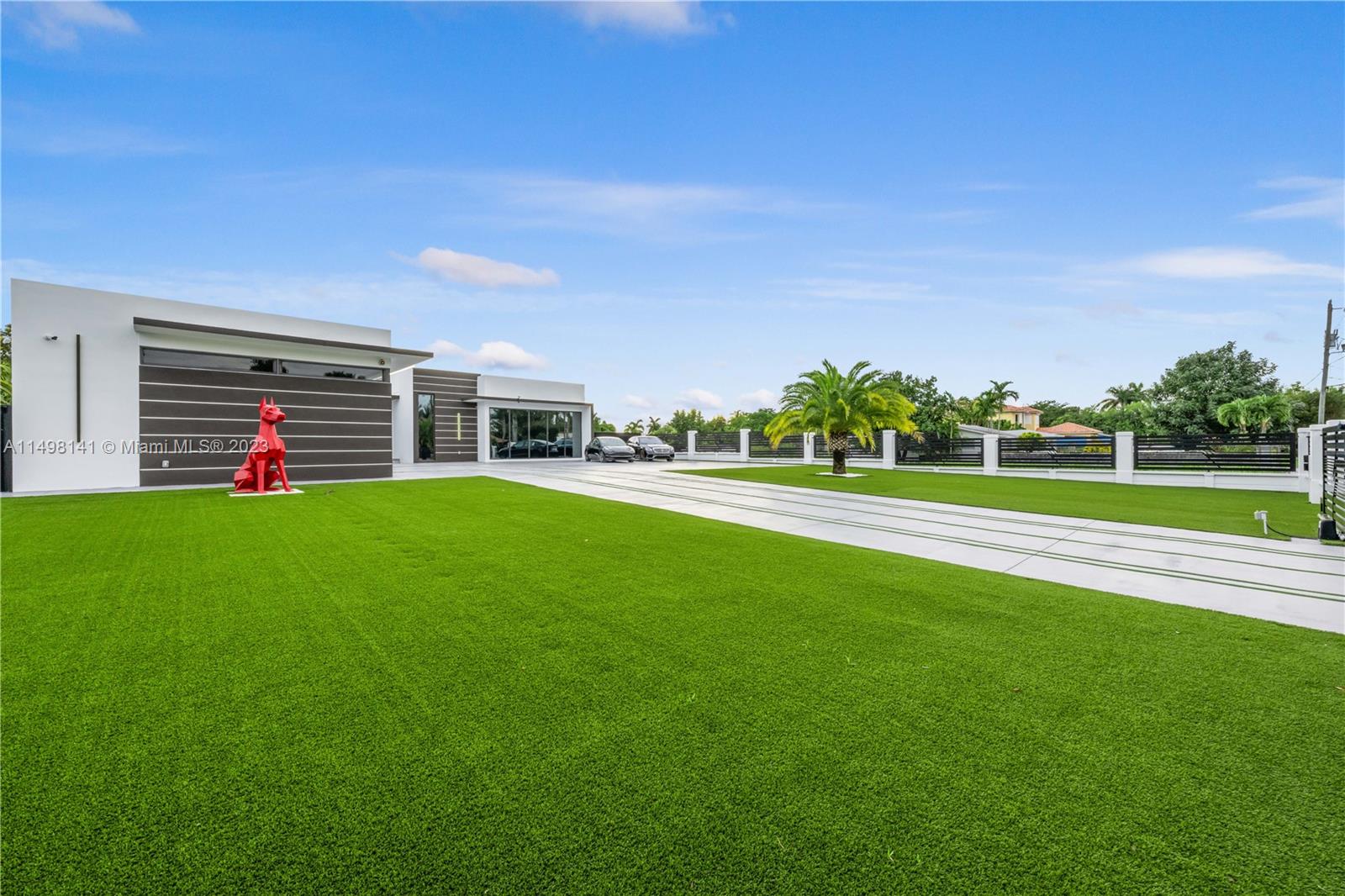 13310 Southwest 34th Street Miami, FL 33175 - Photo 26 of 54 a view of a house with a big yard and large trees