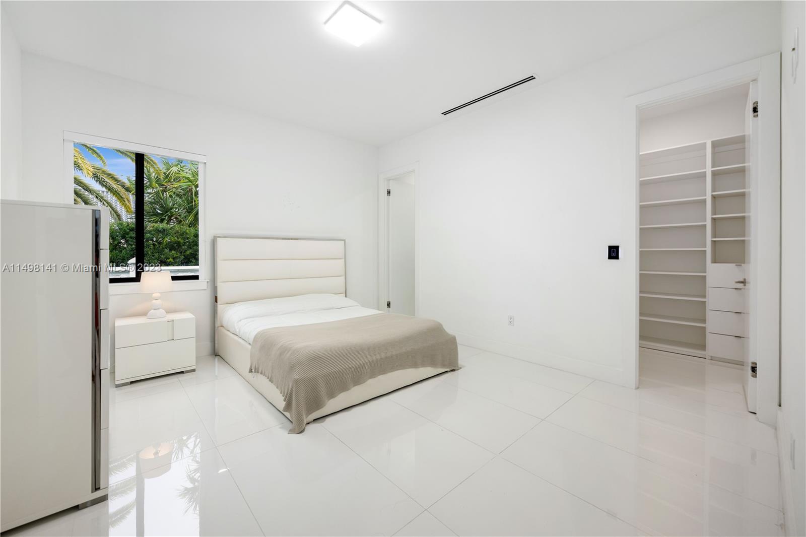 13310 Southwest 34th Street Miami, FL 33175 - Photo 38 of 54 a spacious bedroom with a bed and a window