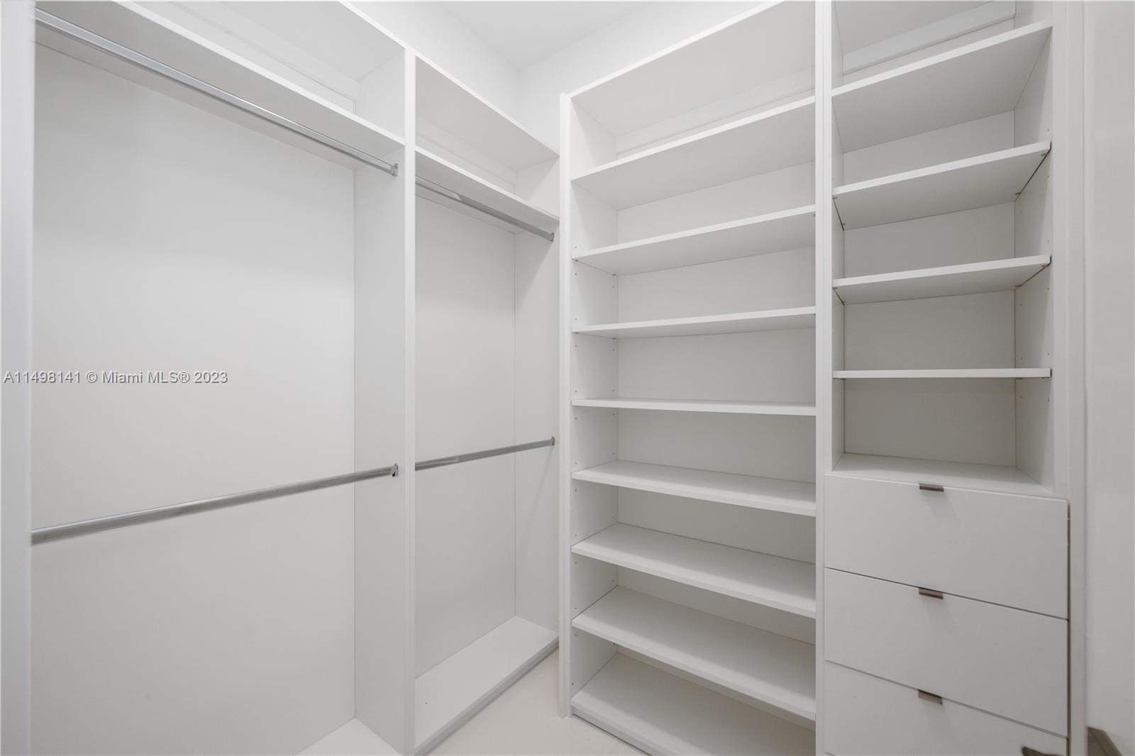 13310 Southwest 34th Street Miami, FL 33175 - Photo 40 of 54 a view of walk in closet with empty racks