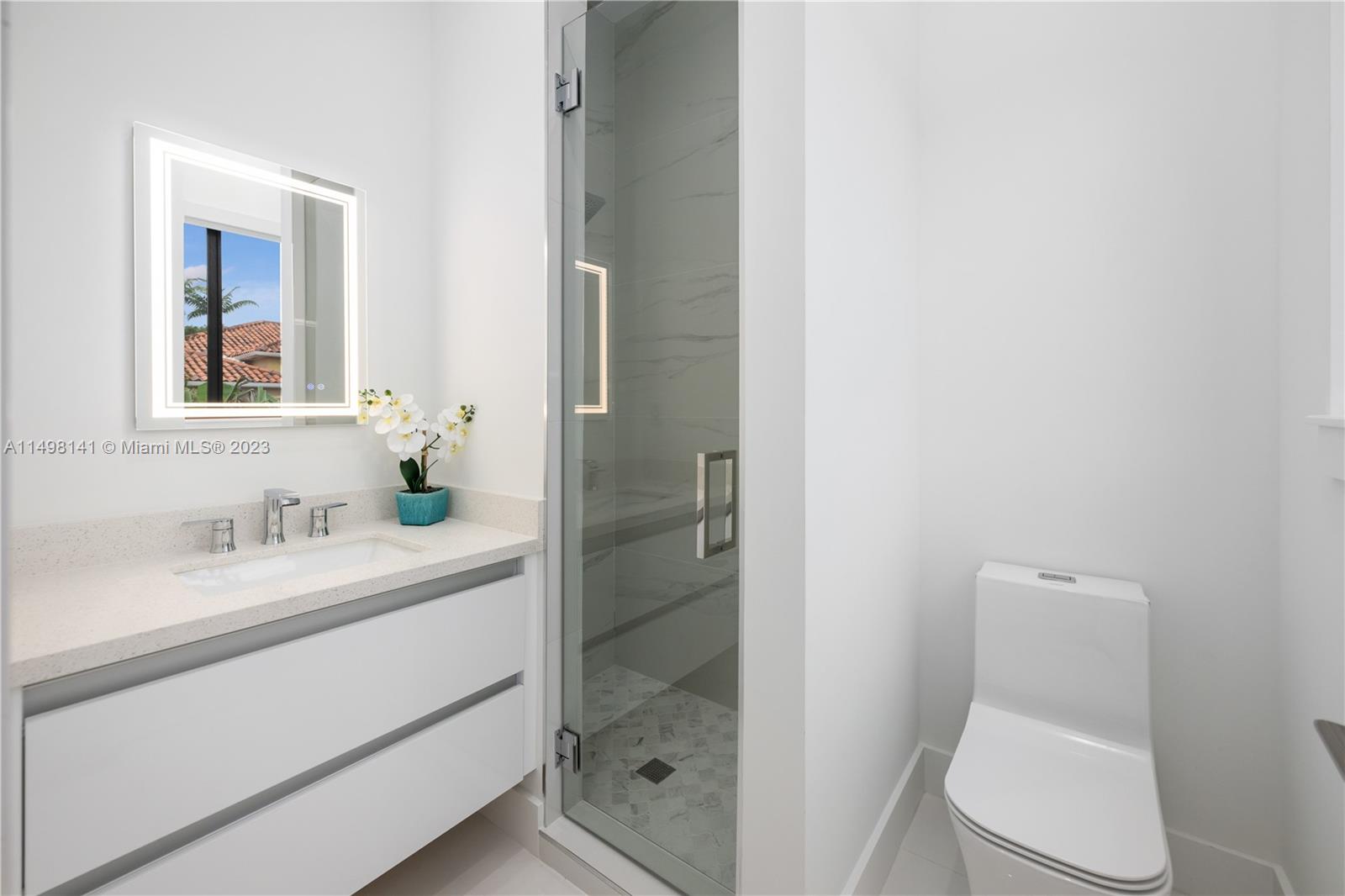 13310 Southwest 34th Street Miami, FL 33175 - Photo 46 of 54 a bathroom with a granite countertop sink toilet and shower