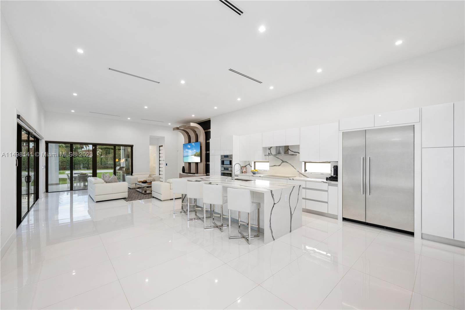 13310 Southwest 34th Street Miami, FL 33175 - Photo 9 of 54 a large white kitchen with a large window and stainless steel appliances
