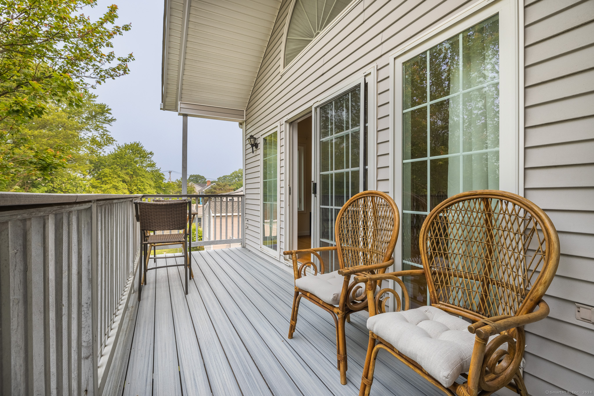 916 Reef Road Fairfield, CT 06824 - Photo 3 of 16 a view of balcony with wooden floor and outdoor seating