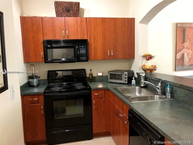 a kitchen with stainless steel appliances granite countertop a stove microwave and sink