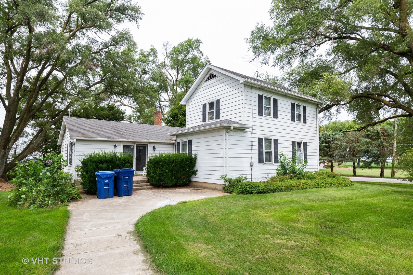 49W179 Main Street Road Maple Park, IL 60151 - Photo 2 of 21 a front view of a house with a yard and potted plants