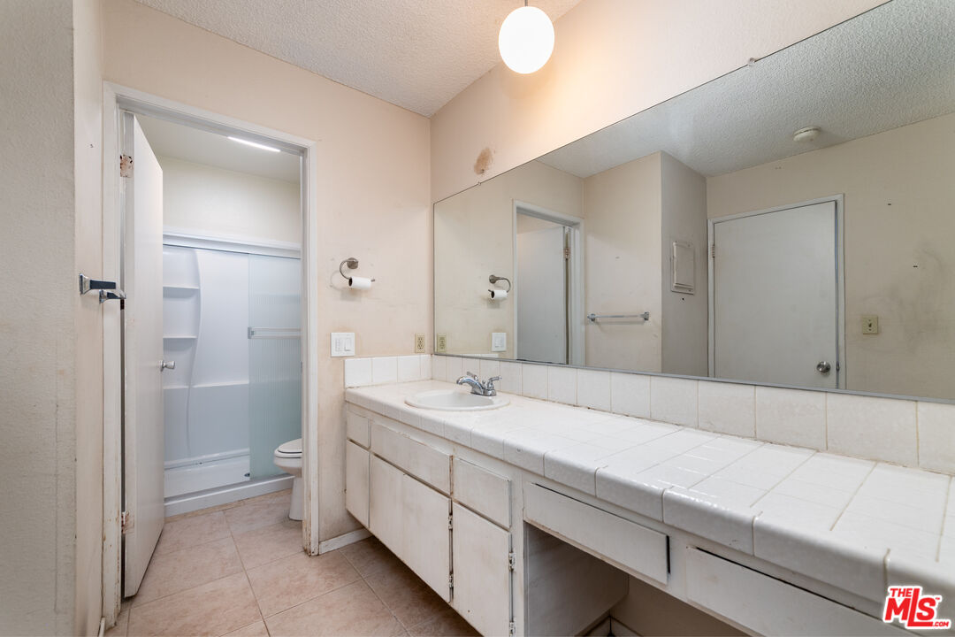 355 South Los Robles Avenue, Unit 108 Pasadena, CA 91101 - Photo 12 of 28 a spacious bathroom with a sink and a mirror