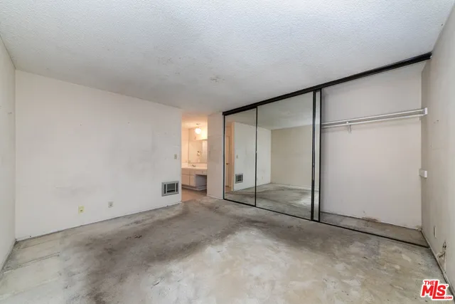 an empty room with closet area