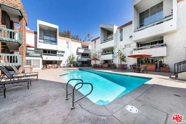 a swimming pool with outdoor seating and yard