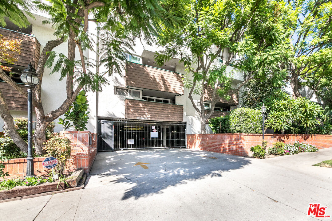355 South Los Robles Avenue, Unit 108 Pasadena, CA 91101 - Photo 3 of 28 a front view of a house with a yard and a garage