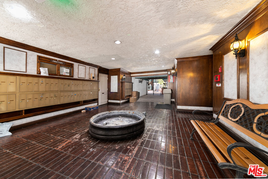355 South Los Robles Avenue, Unit 108 Pasadena, CA 91101 - Photo 4 of 28 a room with wooden floor and furniture