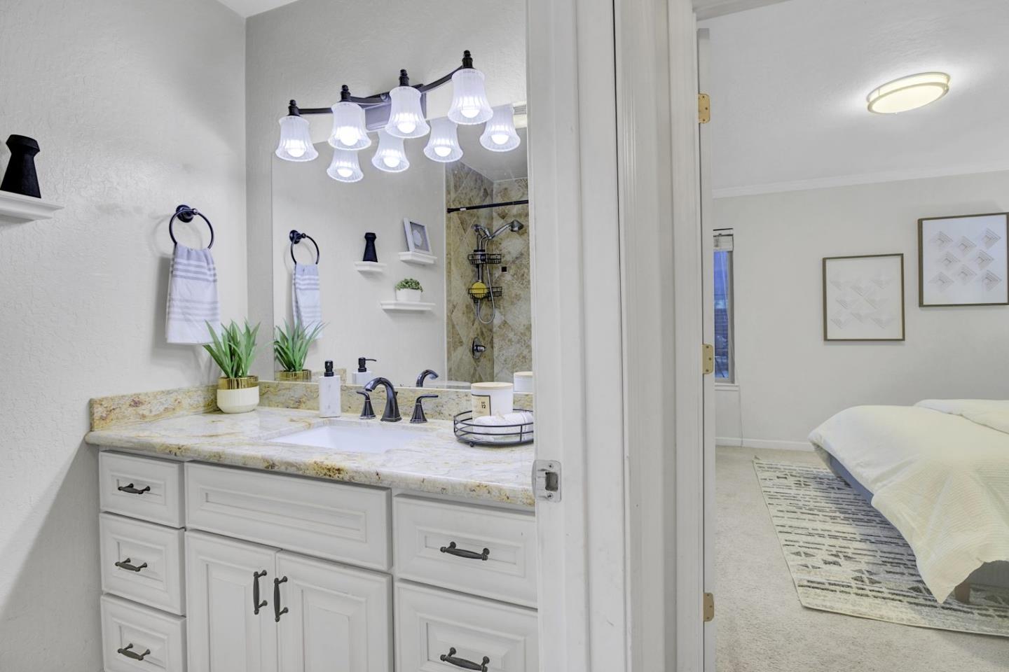 2742 Oak Road, Unit 191 Walnut Creek, CA 94597 - Photo 15 of 36 a bathroom with a granite countertop sink a mirror and a shower