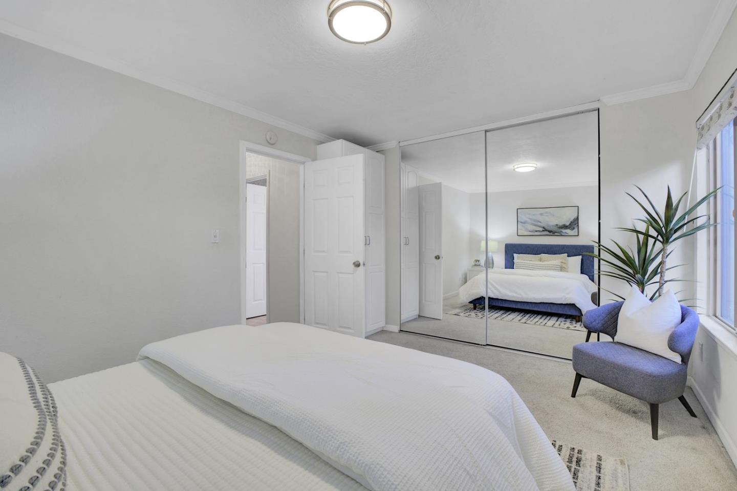 2742 Oak Road, Unit 191 Walnut Creek, CA 94597 - Photo 19 of 36 a bedroom with a large bed and a chair