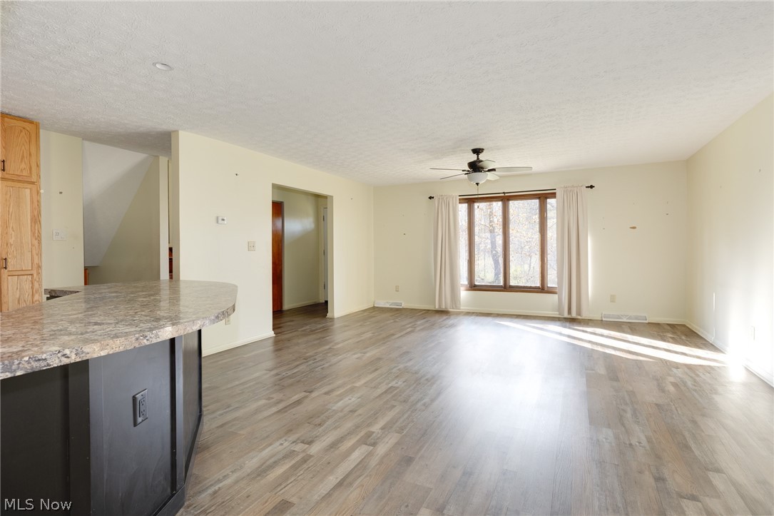 9416 Kieffer Road Mantua, OH 44255 - Photo 8 of 29 Living room with a textured ceiling, light wood-style flooring, and a ceiling fan