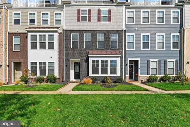 a front view of a residential apartment building with a yard