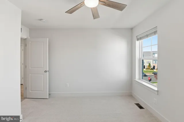 an empty room with windows and painted walls