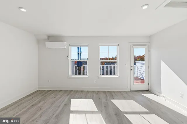 an empty room with windows and entrance