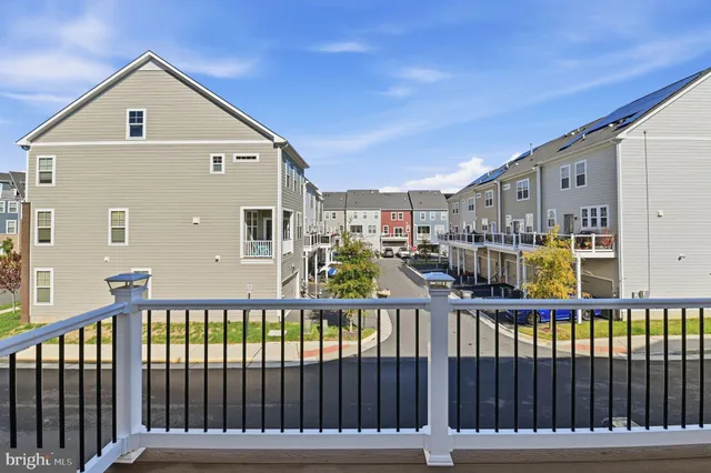 a view of a brick house with a small yard