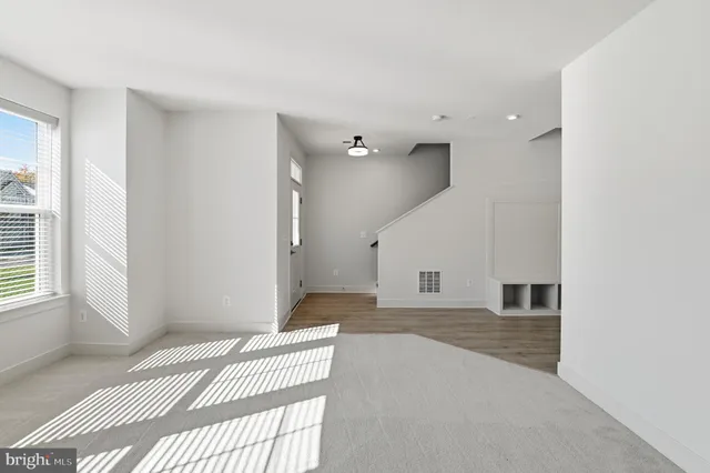 a view of a bedroom with a bed and wooden floor