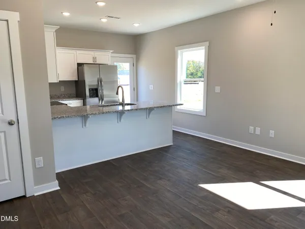 a view of kitchen with wooden floor electronic appliances and window