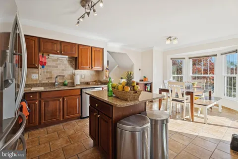 a kitchen with stainless steel appliances granite countertop a sink and cabinets