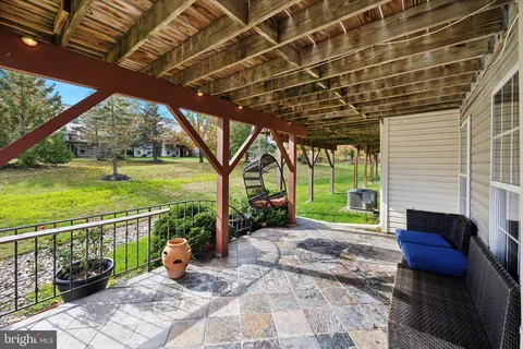 a backyard of a house with outdoor seating