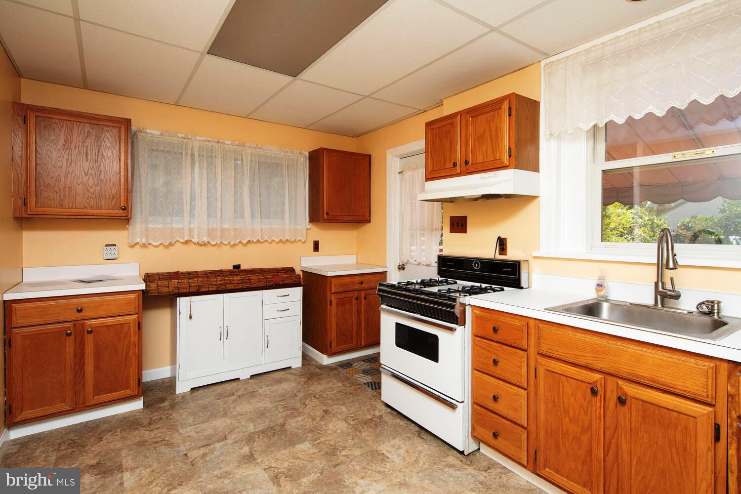 2 Township Line Road Jenkintown, PA 19027 - Photo 11 of 26 a kitchen with granite countertop a sink stove and cabinets