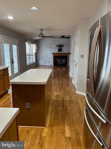 a kitchen with kitchen island a counter top space appliances and cabinets