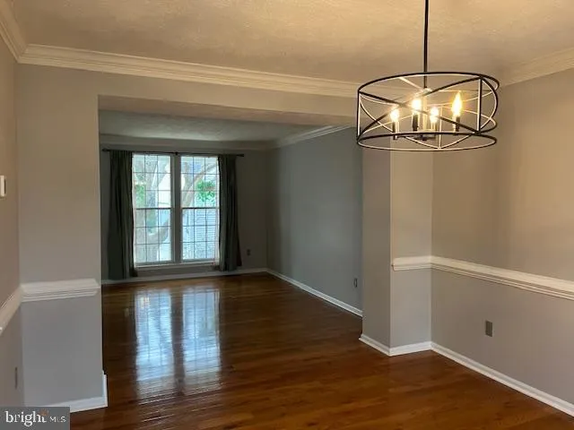 a view of a room with wooden floor and windows