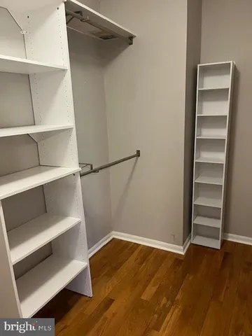a view of walk in closet with empty racks