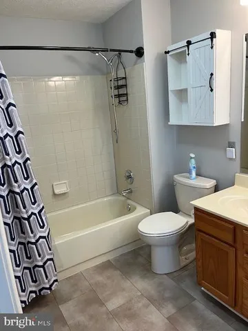 a bathroom with a toilet sink and shower