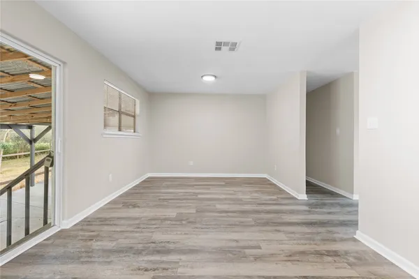 wooden floor in an empty room with a window