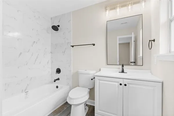 a bathroom with a bathtub and a toilet