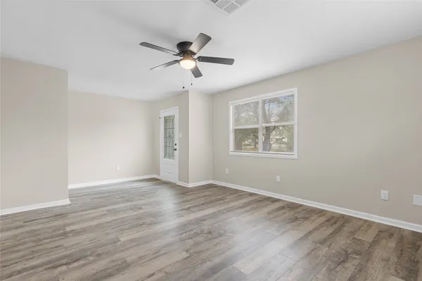 a view of a kitchen with a sink and wooden floor