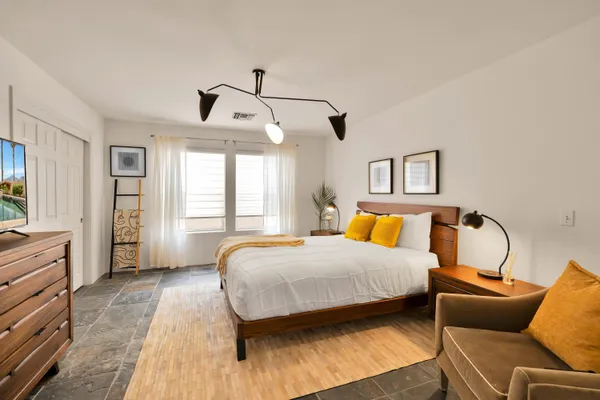 a bedroom with a bed couch and window