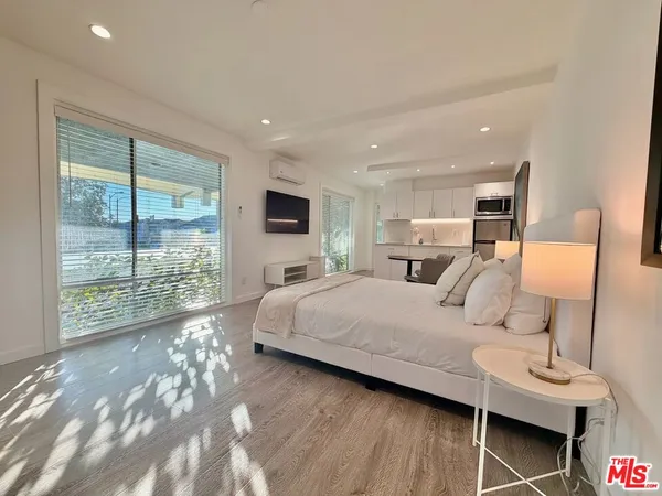 a bed room with a bed and a night stand